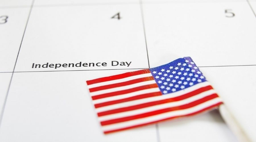 Calendar page for Independence Day with American flag, representing A & W Plumbing and Heating, Inc.'s seasonal services.
