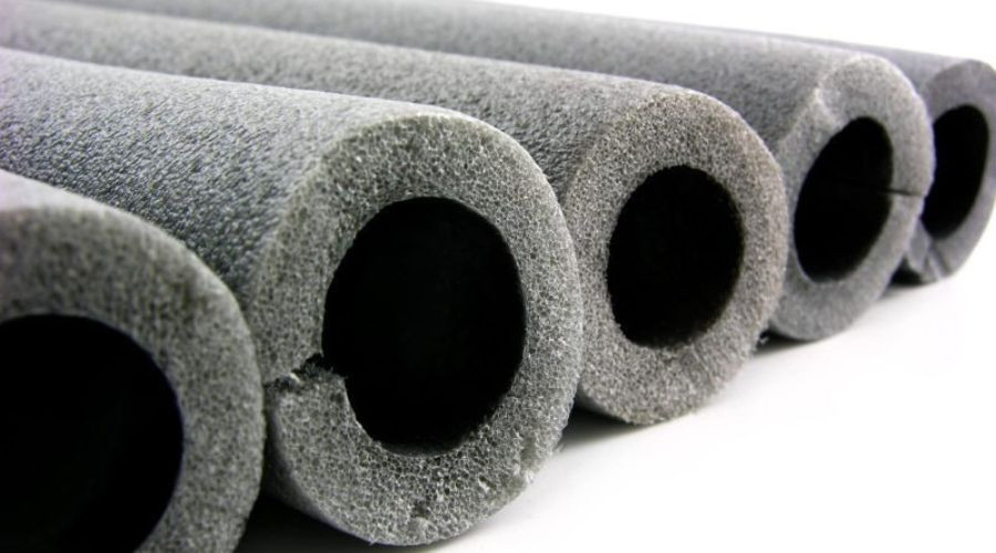 Cylindrical foam pipe insulation tubes with gray texture, featured in A & W Plumbing and Heating services.